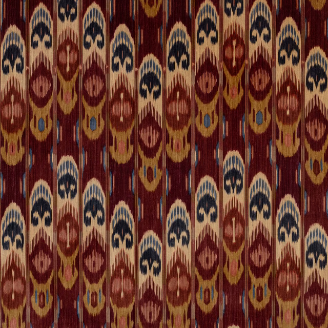 Velvet fabric with vertical ikat-style motifs on a deep brique red ground