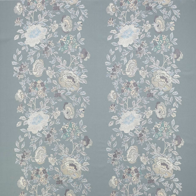 Slate blue floral fabric swatch with pale trailing blooms and leaves