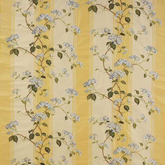 Yellow botanical silk fabric with blossom branches, green leaves and pale blue flowers