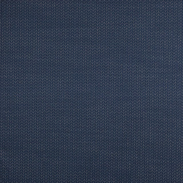 Close-up of deep blue woven geometric fabric with small zigzag rhombus pattern