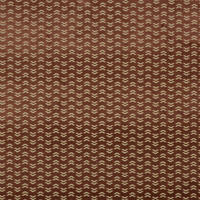 Rose-red patterned fabric swatch with tiny cream geometric repeat