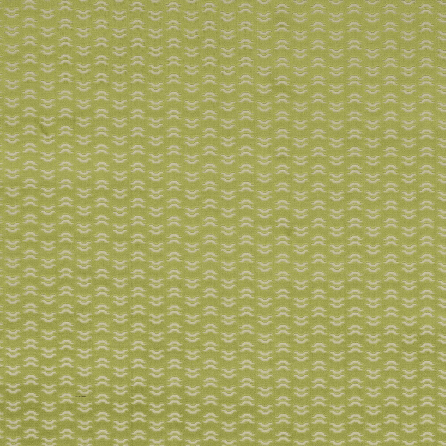 Soft greeny yellow fabric with small cream repeating motif and smooth woven texture