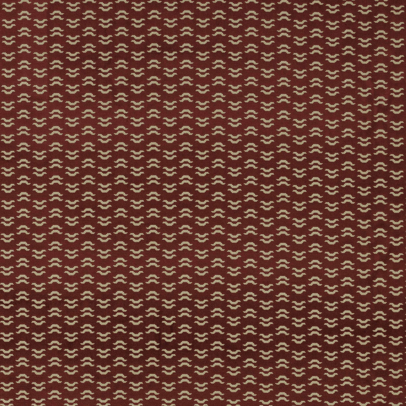 Ruby red patterned fabric with small cream repeat on a smooth woven ground