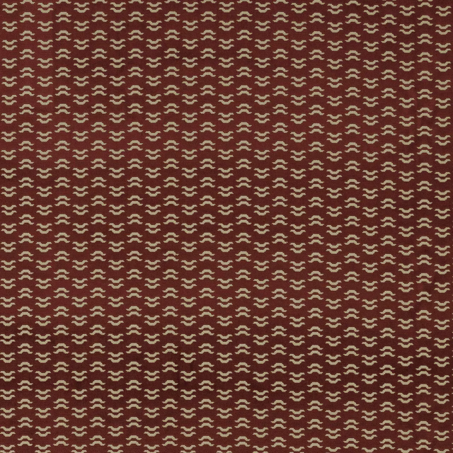 Ruby red patterned fabric with small cream repeat on a smooth woven ground