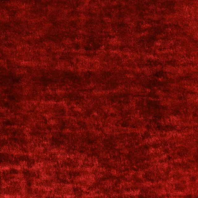Deep ruby red crushed velvet-style fabric with a soft, tonal pile