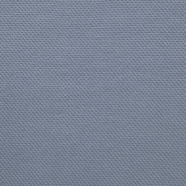 Close-up of a soft dusty blue woven fabric with a tight matte texture
