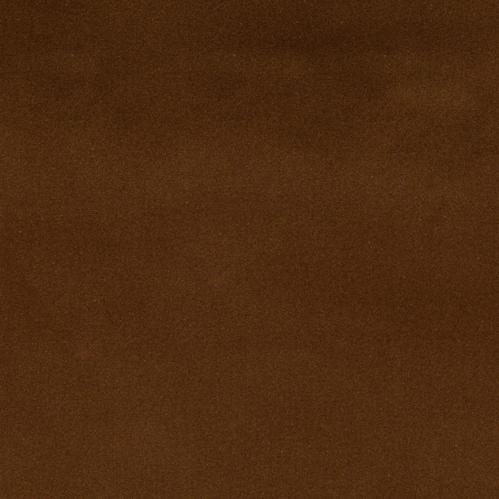 Close-up of a plain rich brown cotton fabric swatch with a softly mottled surface