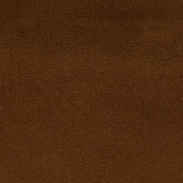 Close-up of a plain rich brown cotton fabric swatch with a softly mottled surface