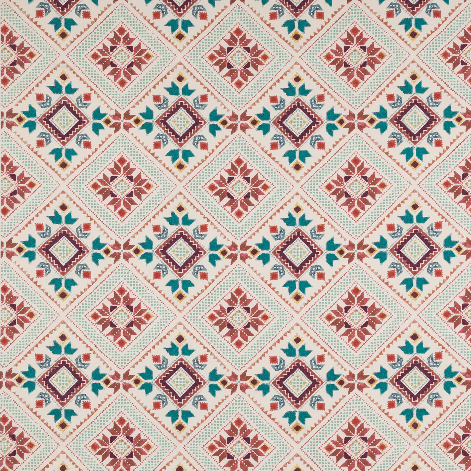 Geometric diamond fabric in rust red, teal and plum on a pale ground