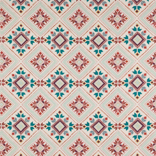 Geometric diamond fabric in rust red, teal and plum on a pale ground