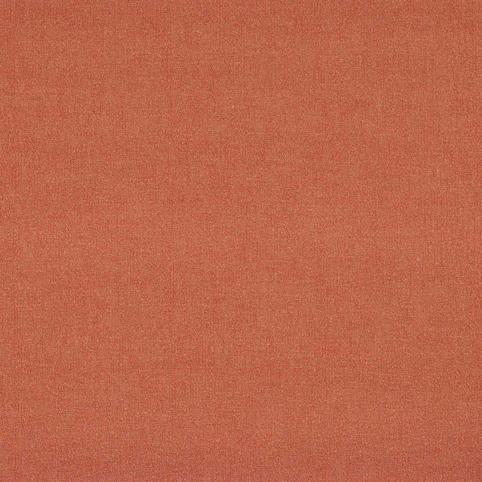 Close-up of a plain warm brick-red woven fabric with fine texture.