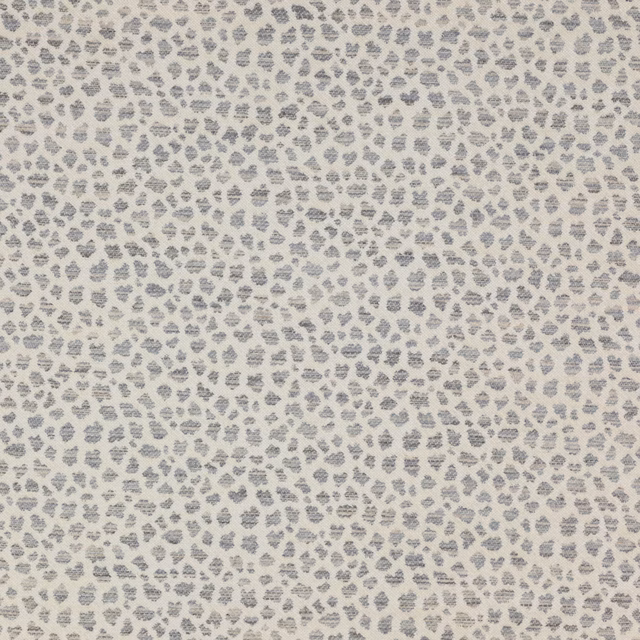 Small silver-grey leopard spot on a pale cream textured ground
