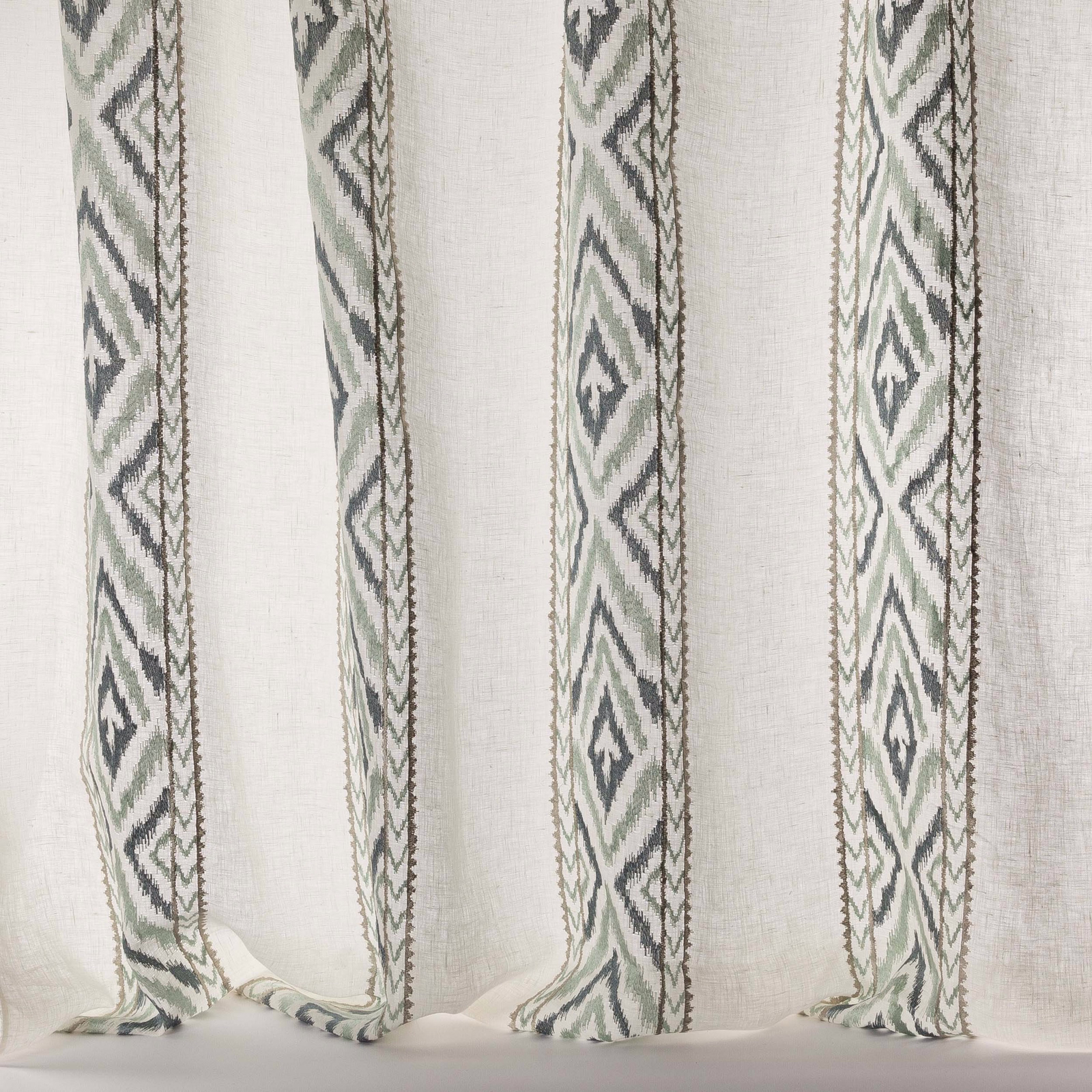 Sheer linen-blend curtain fabric with vertical blue-grey geometric stripes on a pale ground