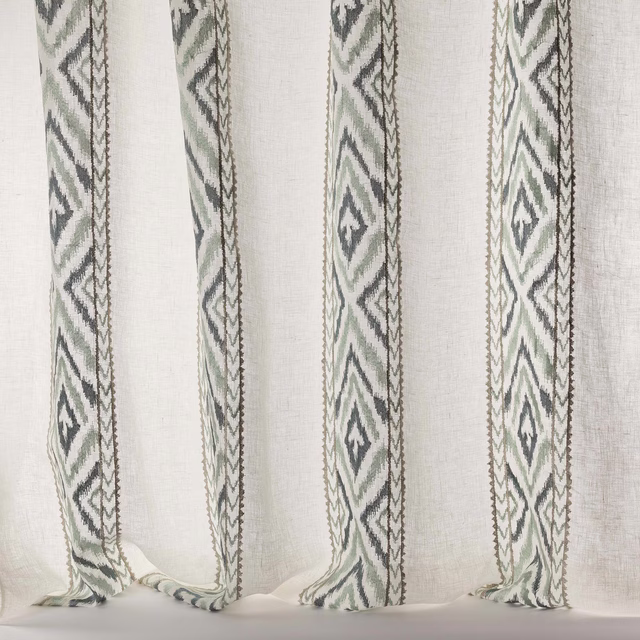Sheer linen-blend curtain fabric with vertical blue-grey geometric stripes on a pale ground