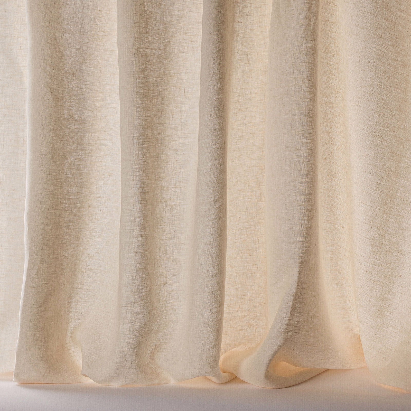Soft warm cream linen sheer curtain with subtle textured weave and gentle folds