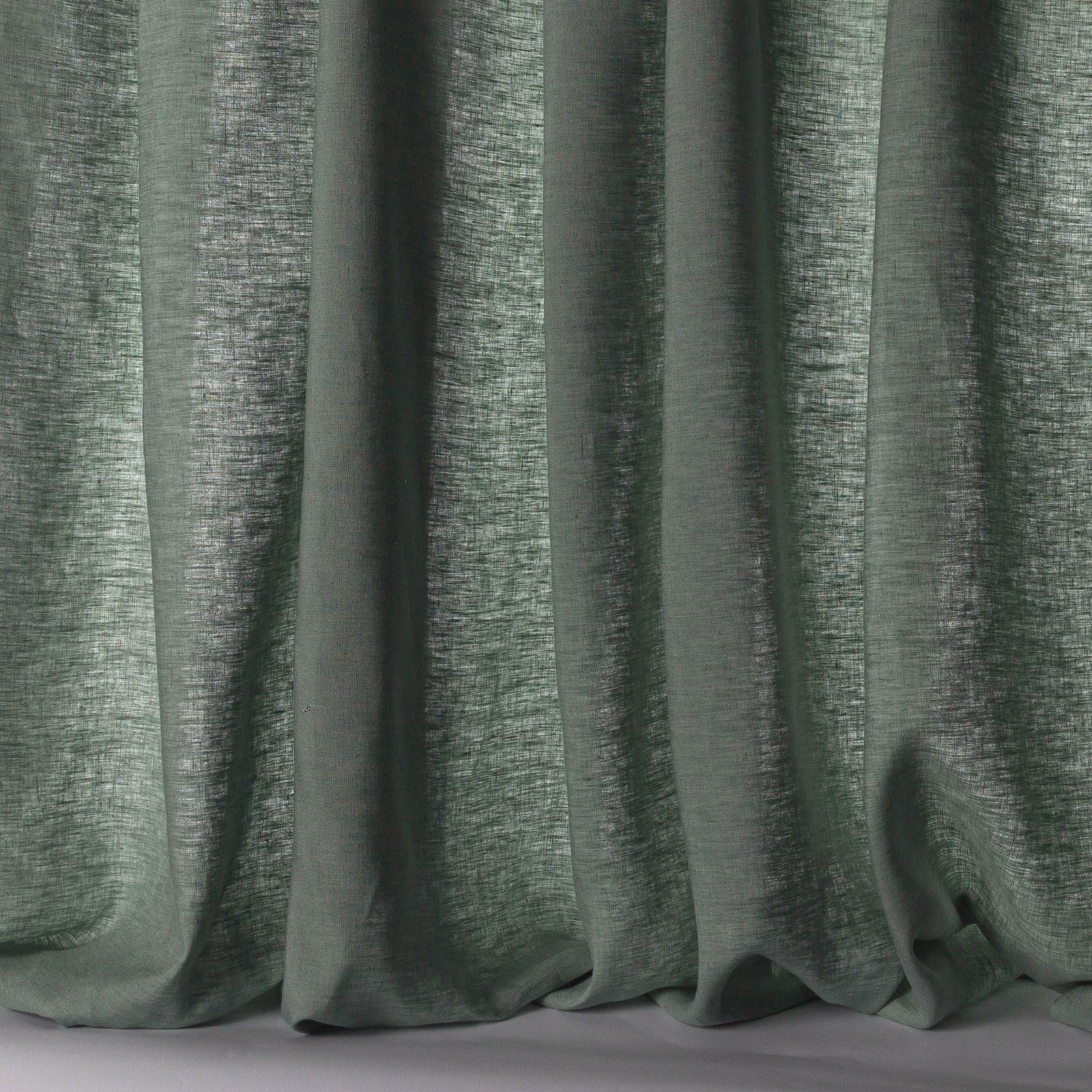 Soft forest green linen sheer with subtle slubbed texture and vertical folds