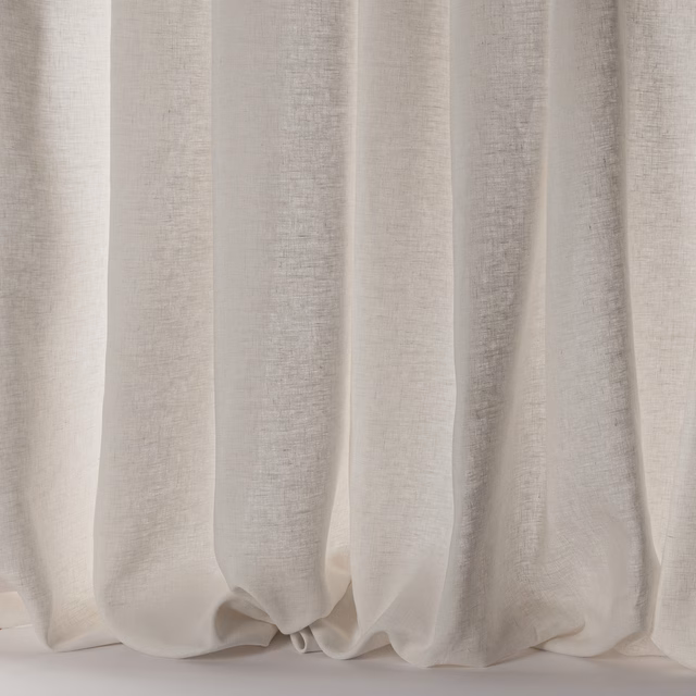 Soft ivory linen sheer curtains hanging in relaxed vertical folds