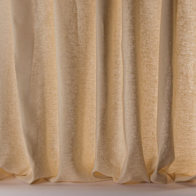 Pale warm beige linen sheer fabric hanging in soft vertical folds