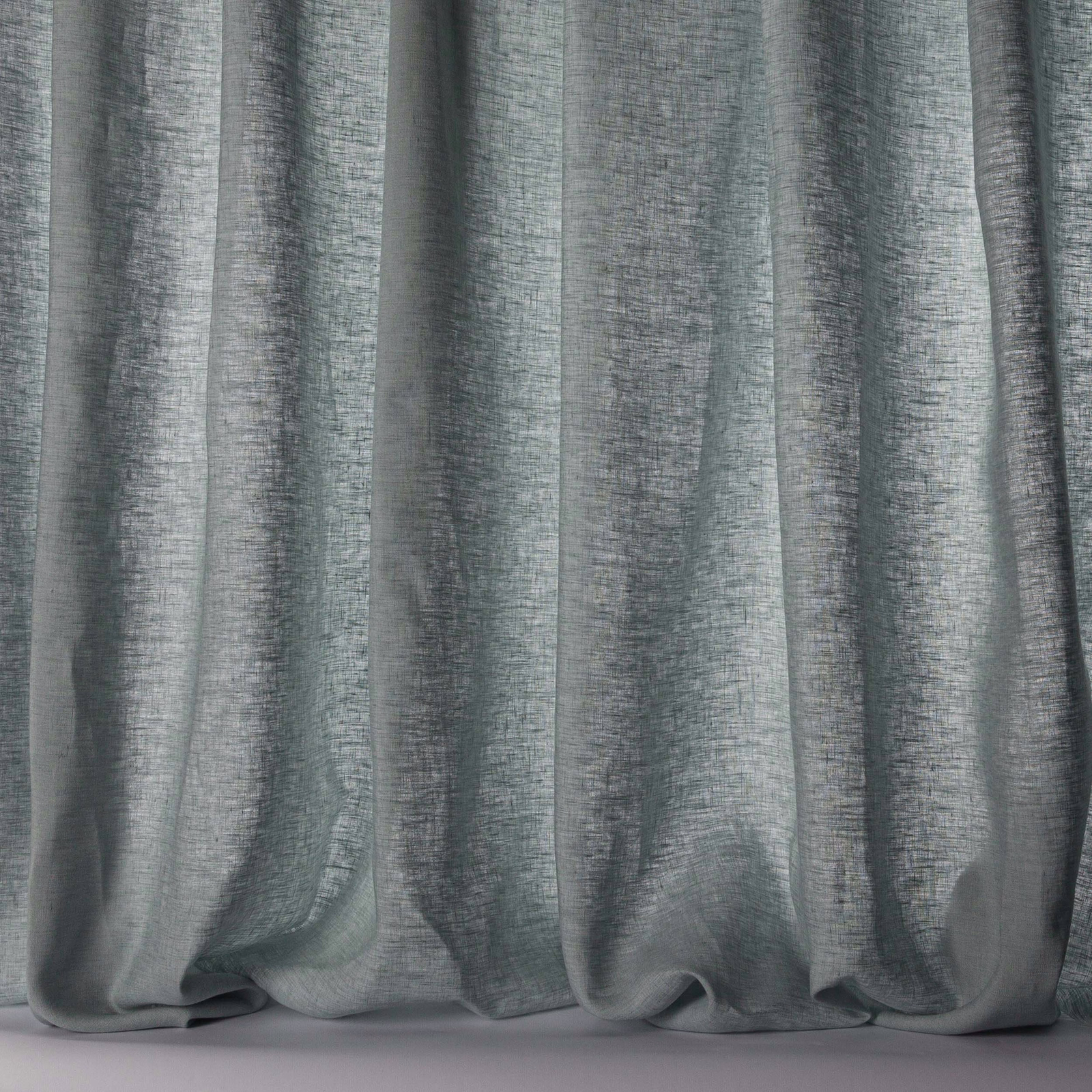 Soft grey-blue linen sheer with a fine slubbed texture and flowing folds