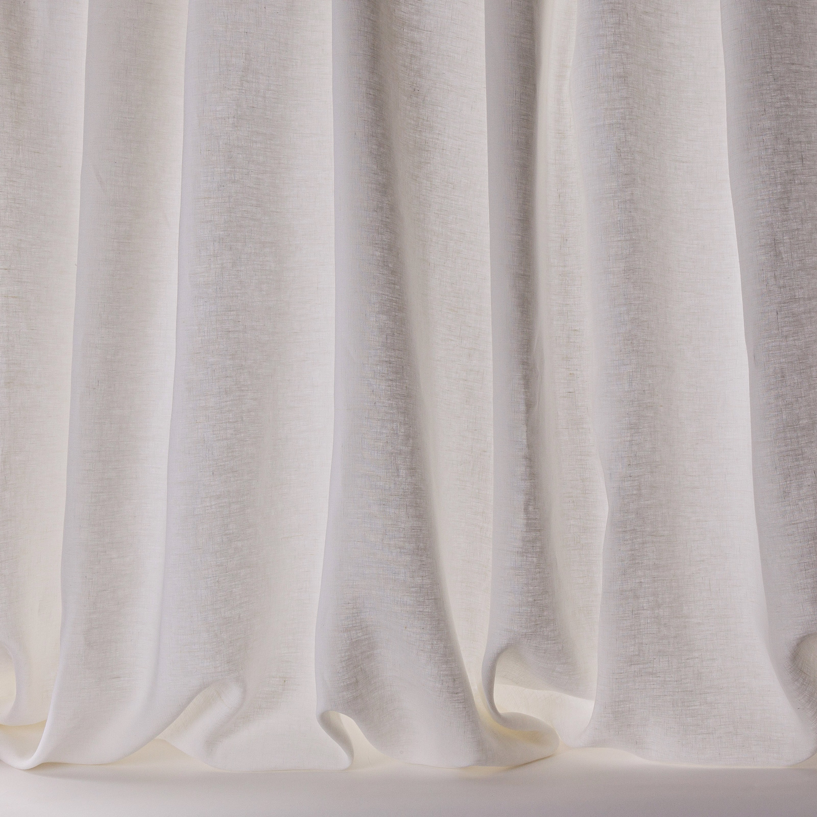 Soft white linen sheer curtains with a fine natural slub and flowing folds