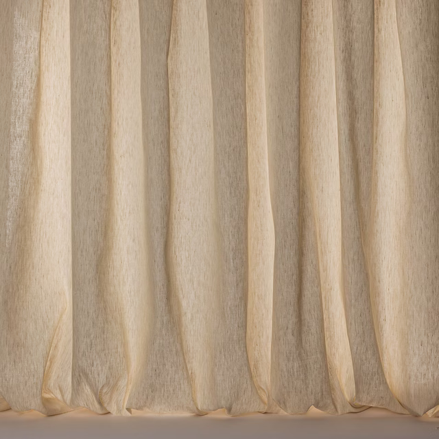 Soft warm cream sheer fabric hanging in vertical folds with a subtle linen slub