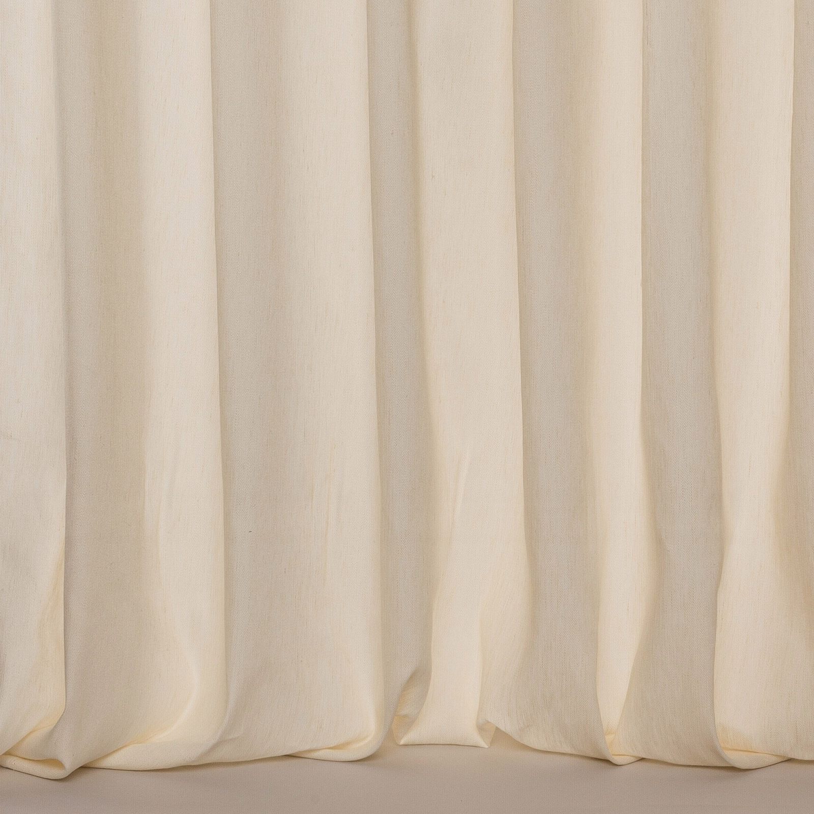 Ivory sheer fabric with soft vertical folds and a lightly textured linen finish
