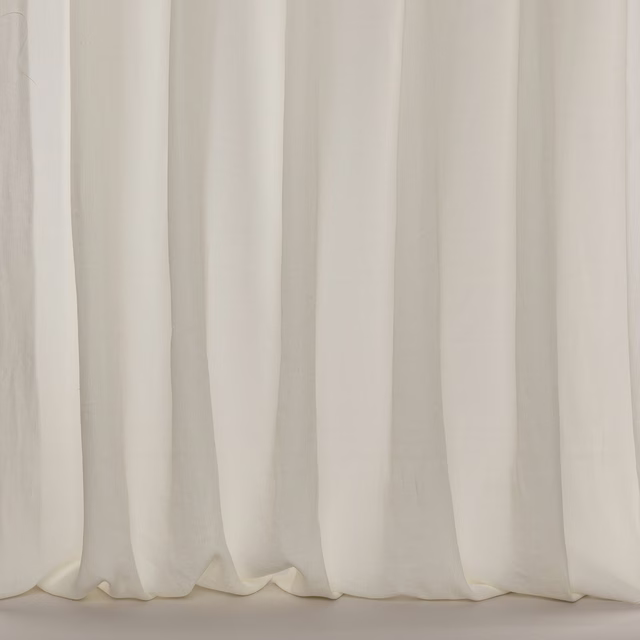 Soft ivory sheer curtain fabric with subtle vertical folds and airy drape