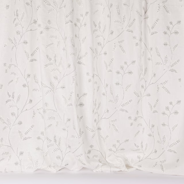 Sheer white fabric with delicate silver vine embroidery and tiny leaf motifs