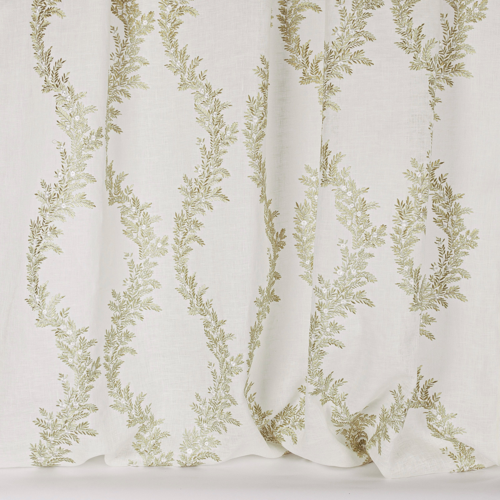 Cream sheer fabric with trailing soft green leaf embroidery