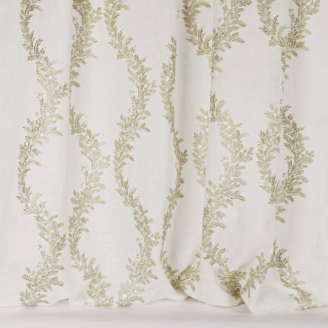 Cream sheer fabric with trailing soft green leaf embroidery