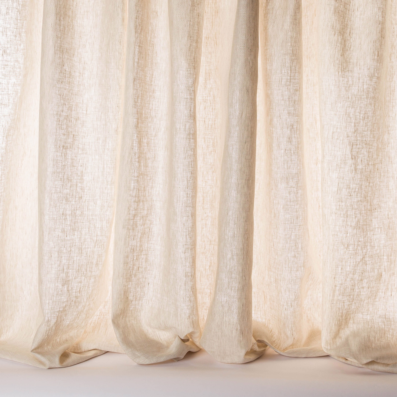Soft beige linen sheer curtains with a light slubbed weave and gentle vertical folds