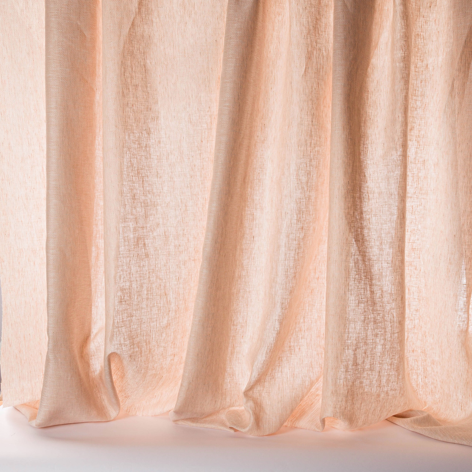 Sheer old pink linen fabric with soft vertical folds and natural texture