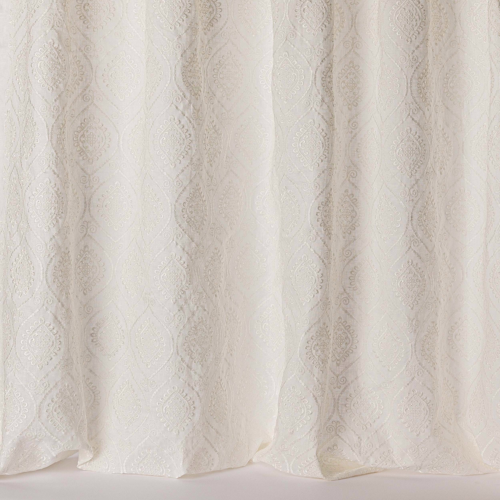 Ivory sheer fabric with subtle tonal damask medallions and soft gathered folds