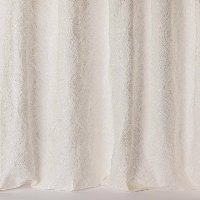 Ivory sheer fabric with subtle tonal damask medallions and soft gathered folds