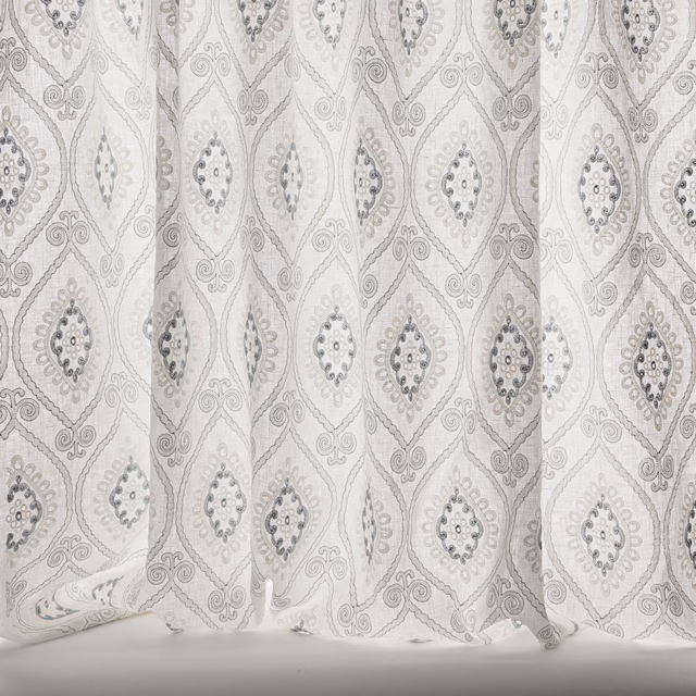 Sheer damask curtain fabric in soft old blue and ivory with diamond motifs