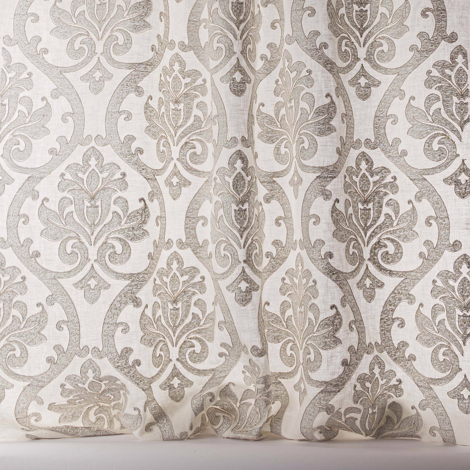Silver-grey damask sheer fabric with a pale ground and large scrolling motif