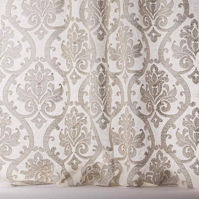 Silver-grey damask sheer fabric with a pale ground and large scrolling motif