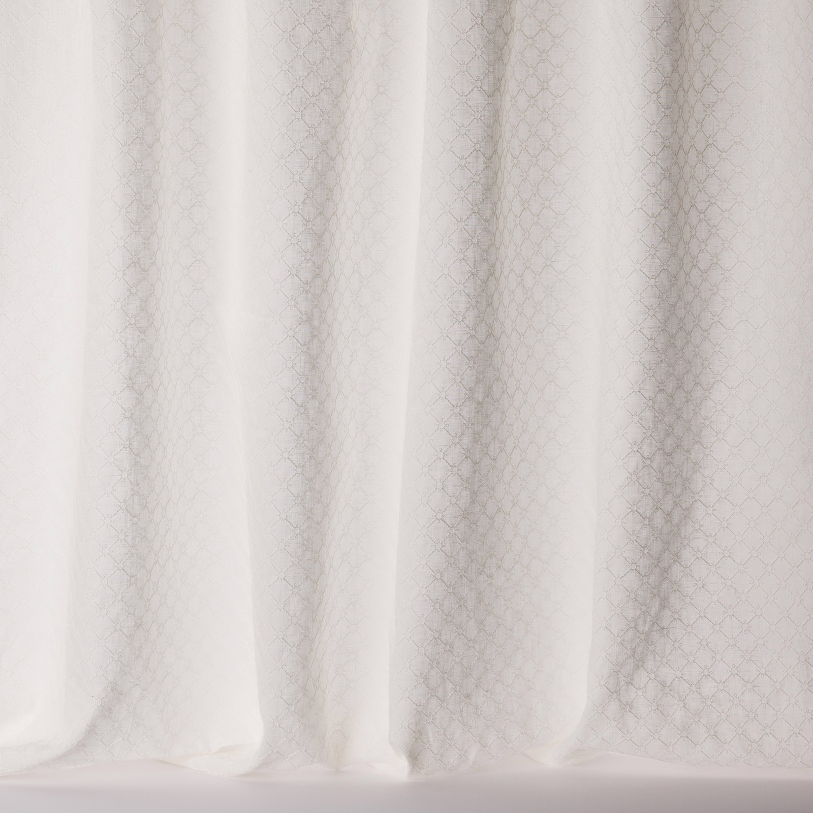 Ivory sheer fabric with tiny geometric diamond pattern and soft vertical folds