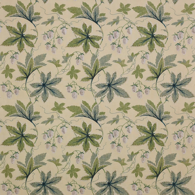 Large leafy botanical fabric in soft green and blue-green on a pale ground