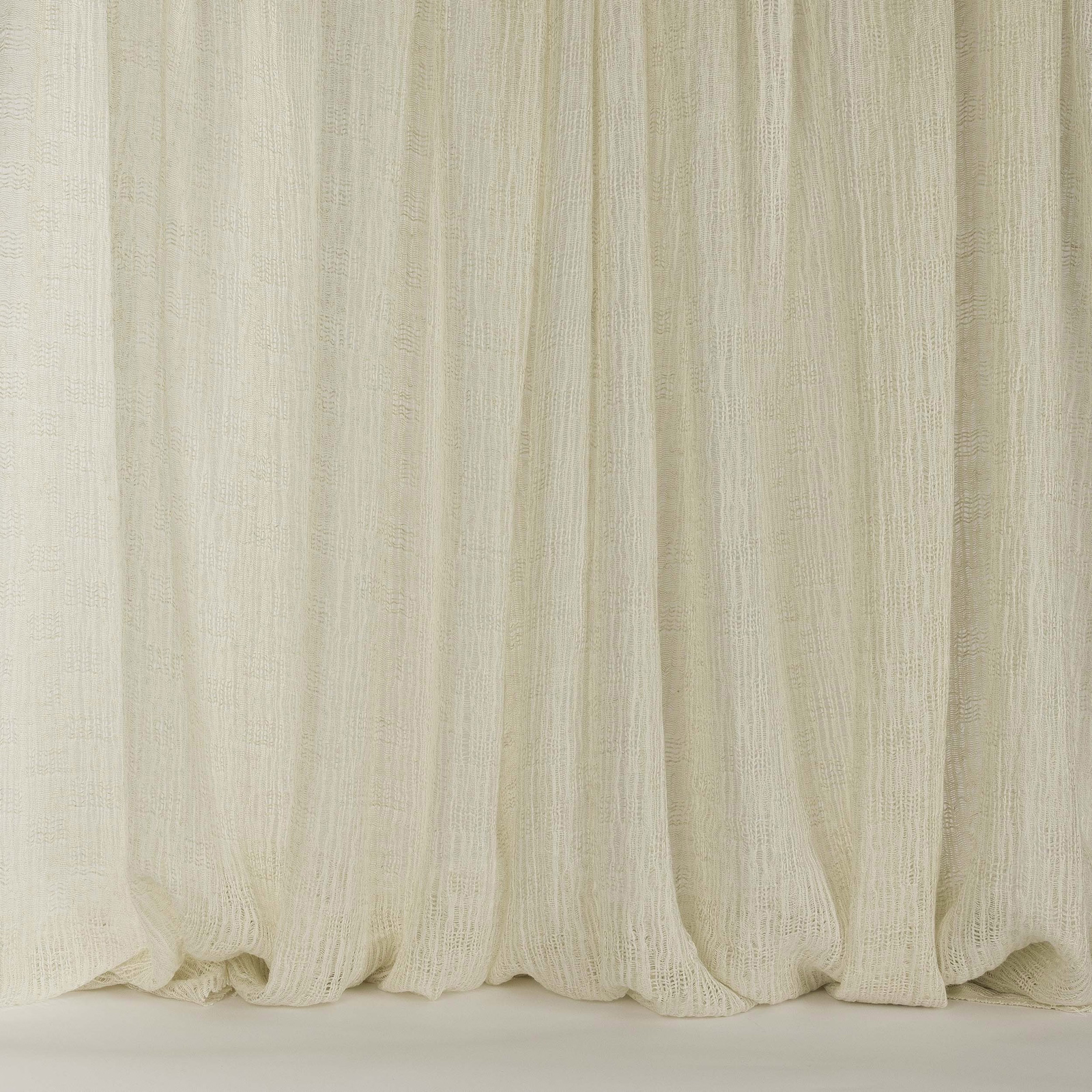 Cream ivory linen curtain fabric with soft vertical striations and a sheer texture