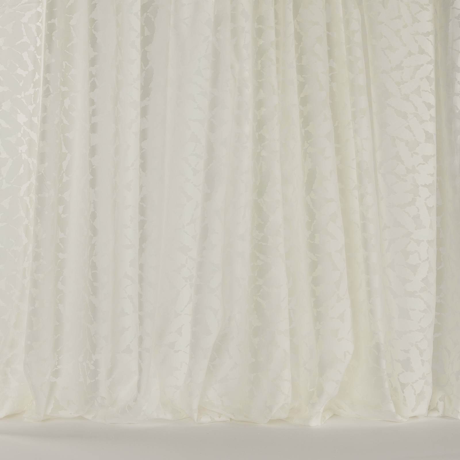 Soft ivory floral curtain fabric with subtle tonal texture and gentle folds