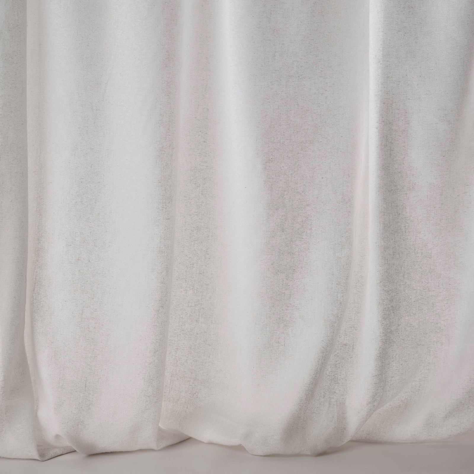 Soft mastic cream fabric shown in wide draped folds with a lightly lustrous plain weave