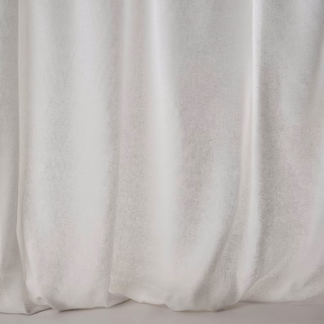 Soft mastic cream fabric shown in wide draped folds with a lightly lustrous plain weave