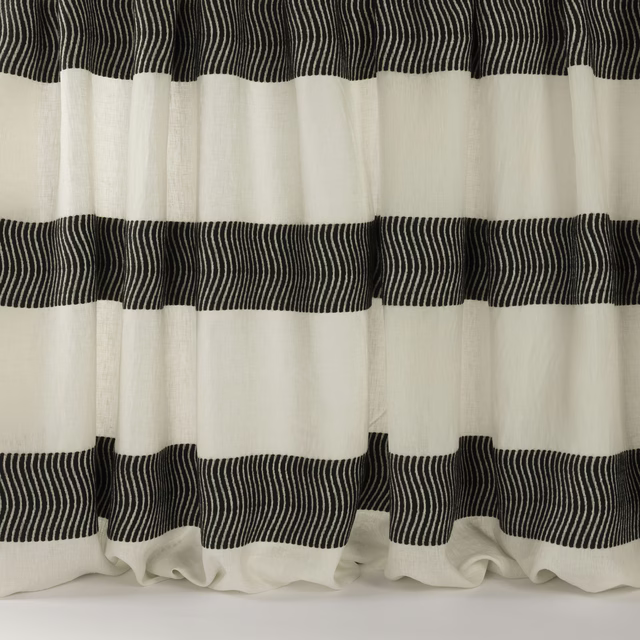 Black fine-striped bands on an ivory woven fabric draped in wide folds