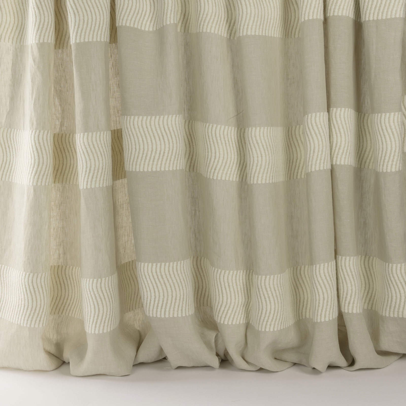 Beige striped curtain fabric with soft woven bands and a relaxed drape