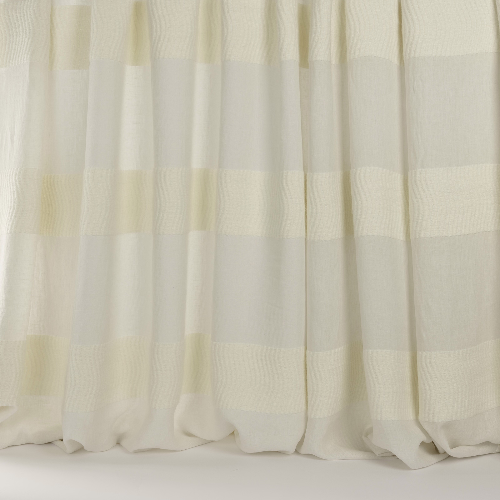 Sheer ivory striped fabric with soft woven bands and a relaxed drape