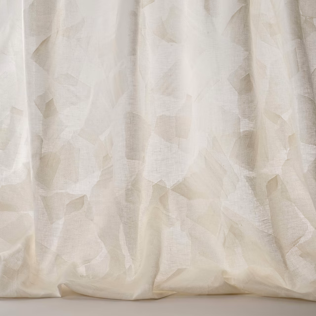 Creamy white geometric fabric with soft tonal pattern and linen texture