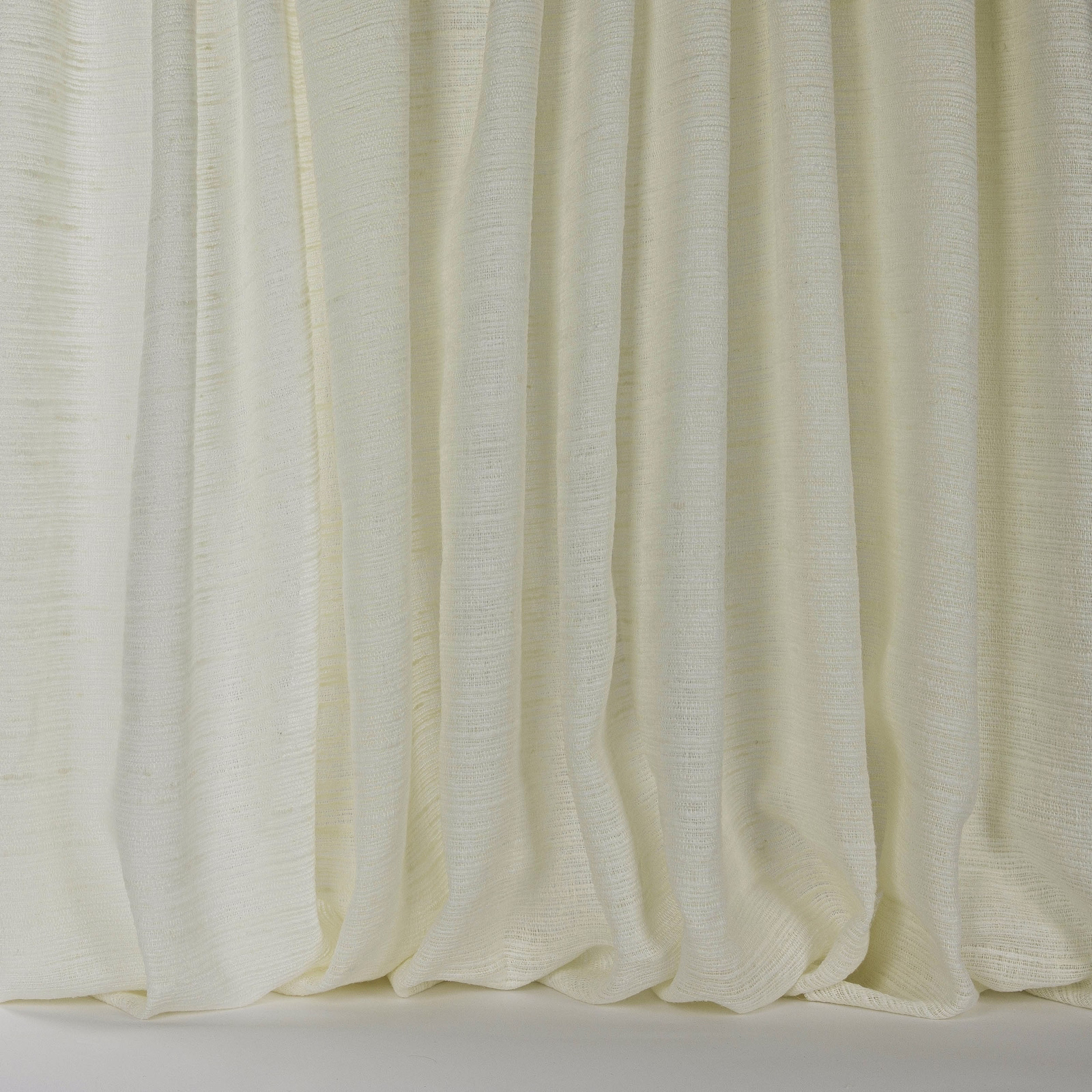 Soft ivory cream linen-blend fabric hanging in gentle vertical folds