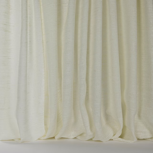 Soft ivory cream linen-blend fabric hanging in gentle vertical folds