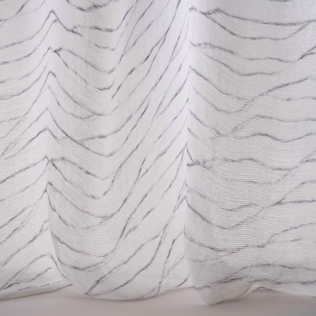 Soft white fabric with charcoal wavy chevron tracery and fluid drape
